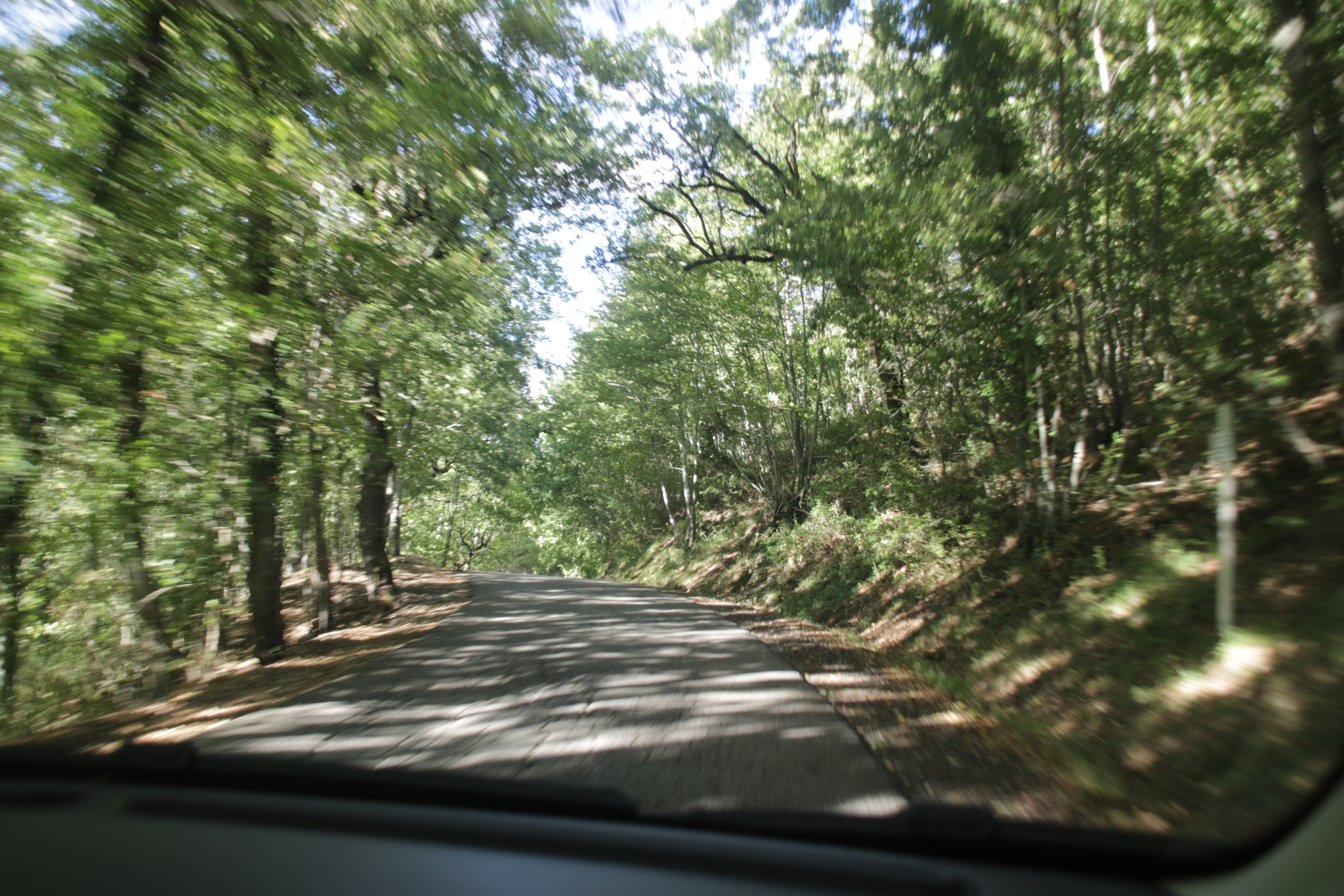 Canon EOS 760D (EOS Rebel T6s / EOS 8000D) + Sigma 18-200mm f/3.5-6.3 DC OS sample photo. Driving fast down a country road photography