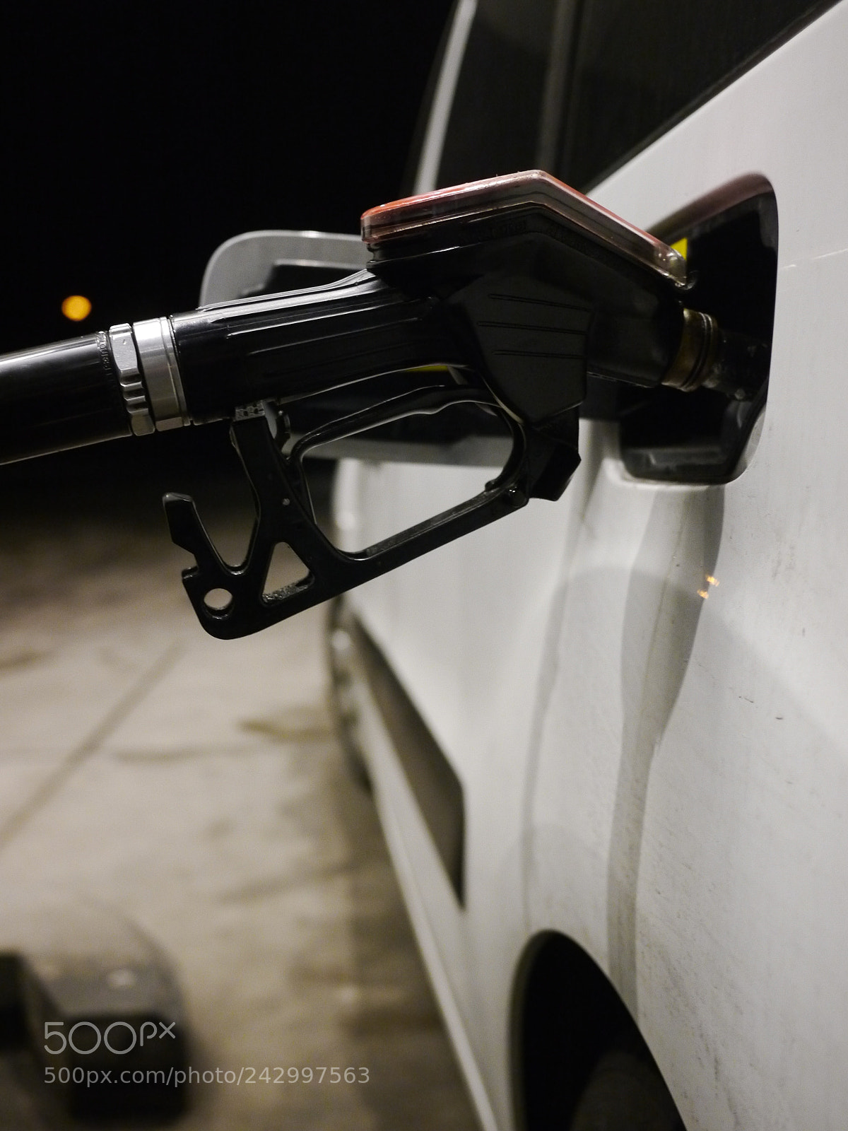 Panasonic Lumix DMC-GH2 sample photo. Someone filling up car photography