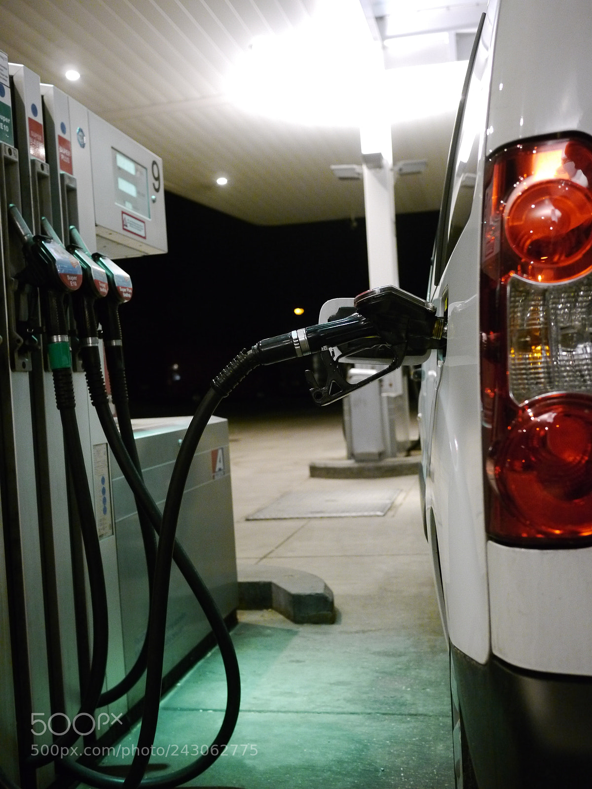 Panasonic Lumix DMC-GH2 sample photo. Someone filling up car photography