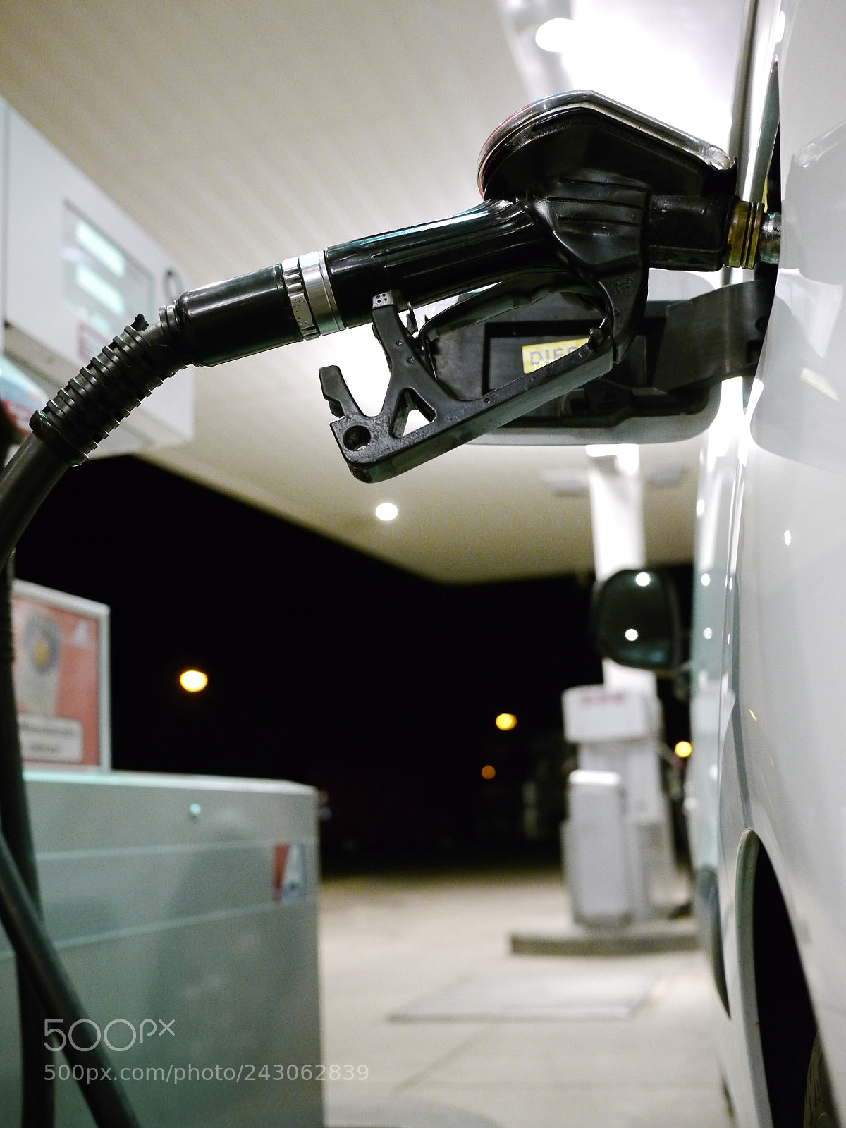 Panasonic Lumix DMC-GH2 sample photo. Someone filling up car photography