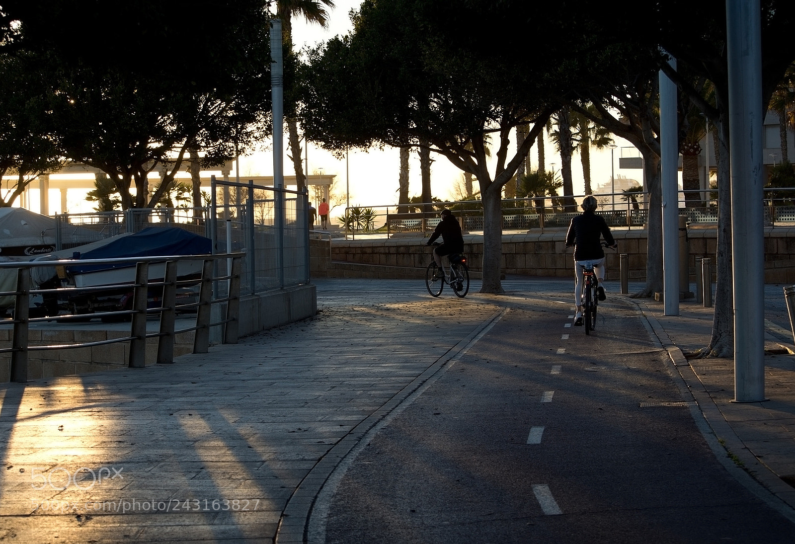 Nikon D7100 sample photo. Silhouette bicyclists along biketrack photography