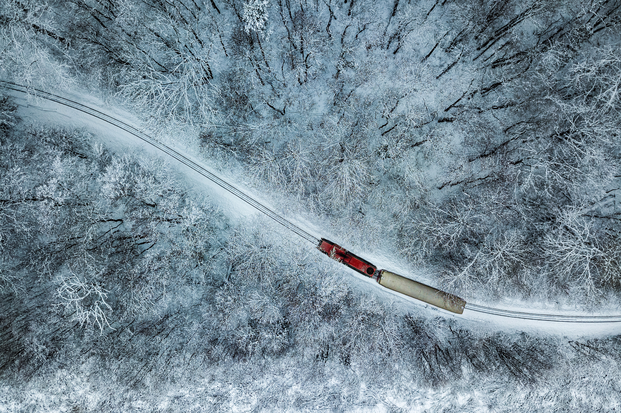 Budapest, Hungary - Aerial view of snowy forest with red train