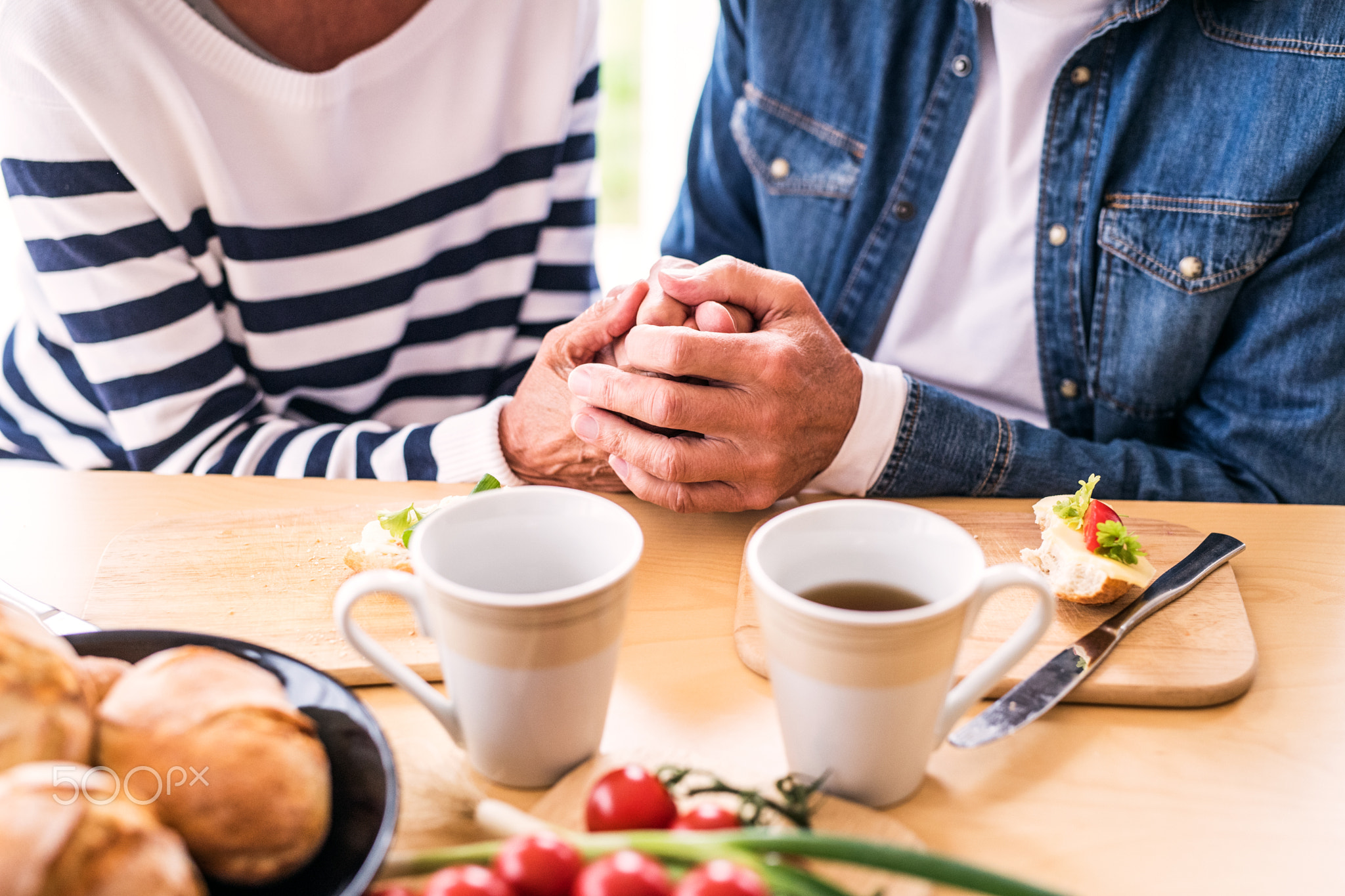 Senior couple eating breakfast at home.