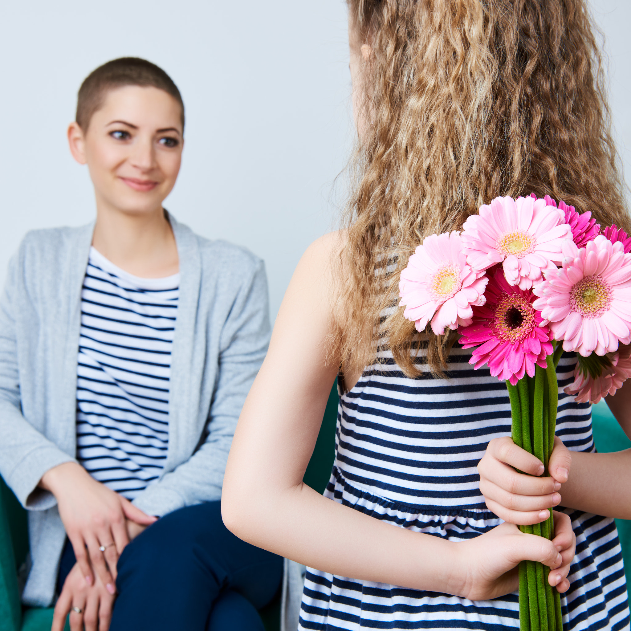Nikon AF-S Nikkor 24-70mm F2.8G ED sample photo. Happy mother's day, women's day or birthday. cute little girl giving mom bouquet of pink gerbera... photography