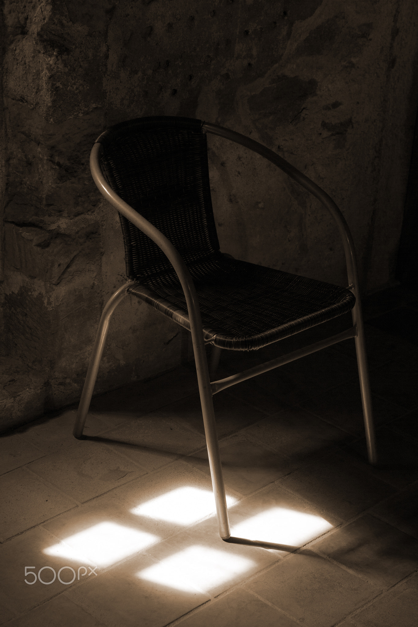 Retro chair in sunshine in sepia color