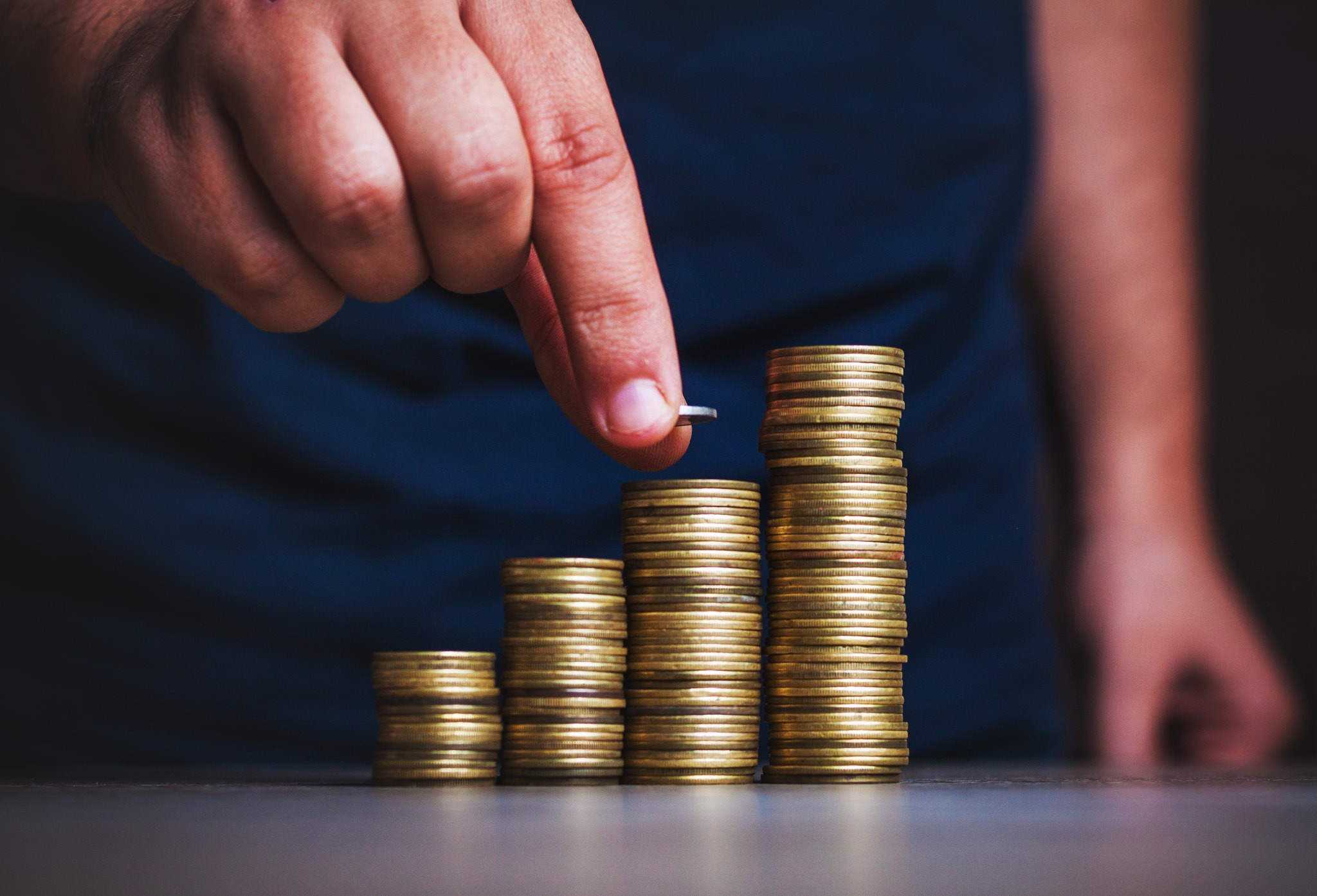 Man's hand put money coins to stack of coins. Money, Financial,