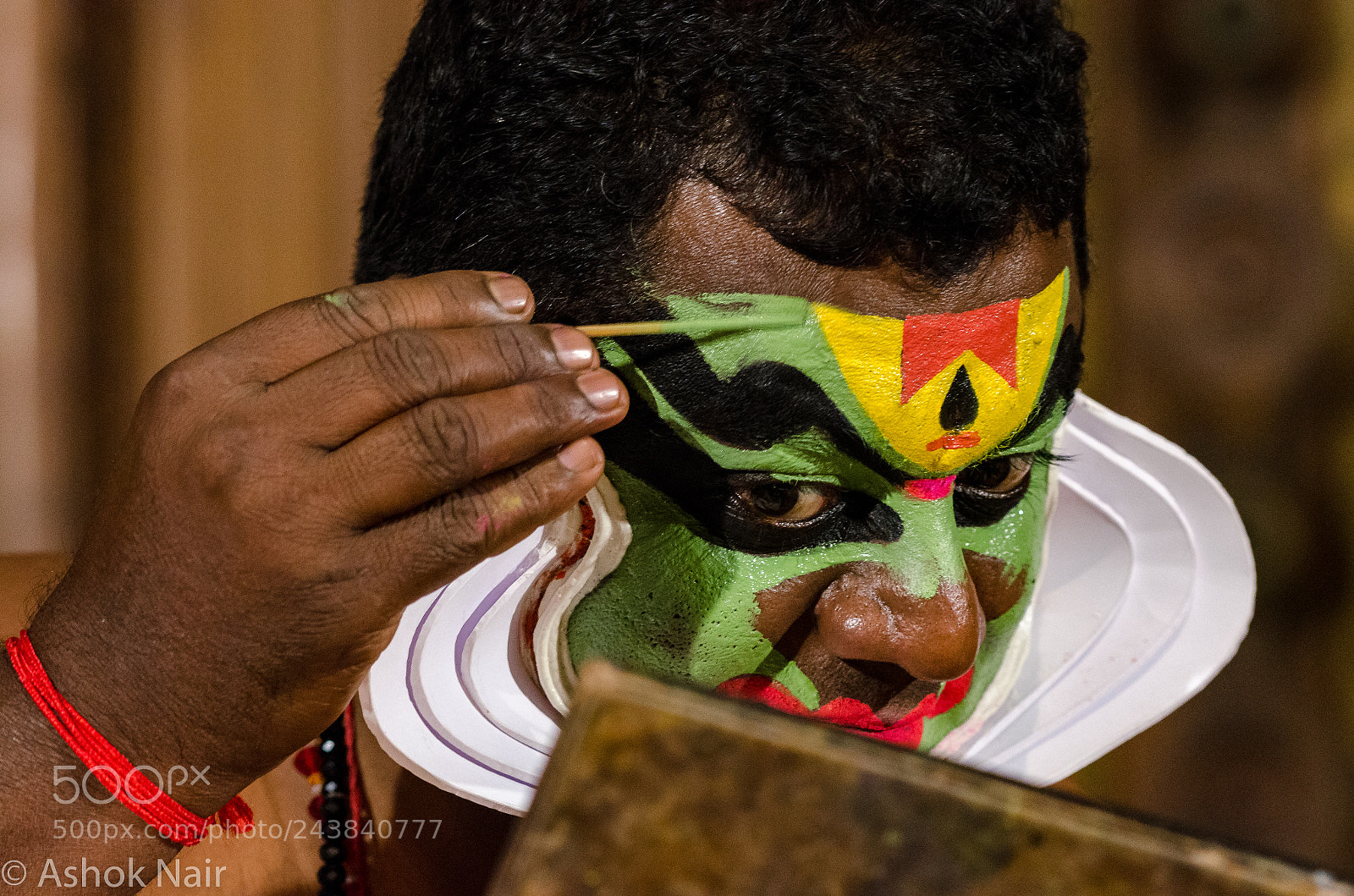 Nikon D5100 sample photo. Kathakali artiste applying make photography