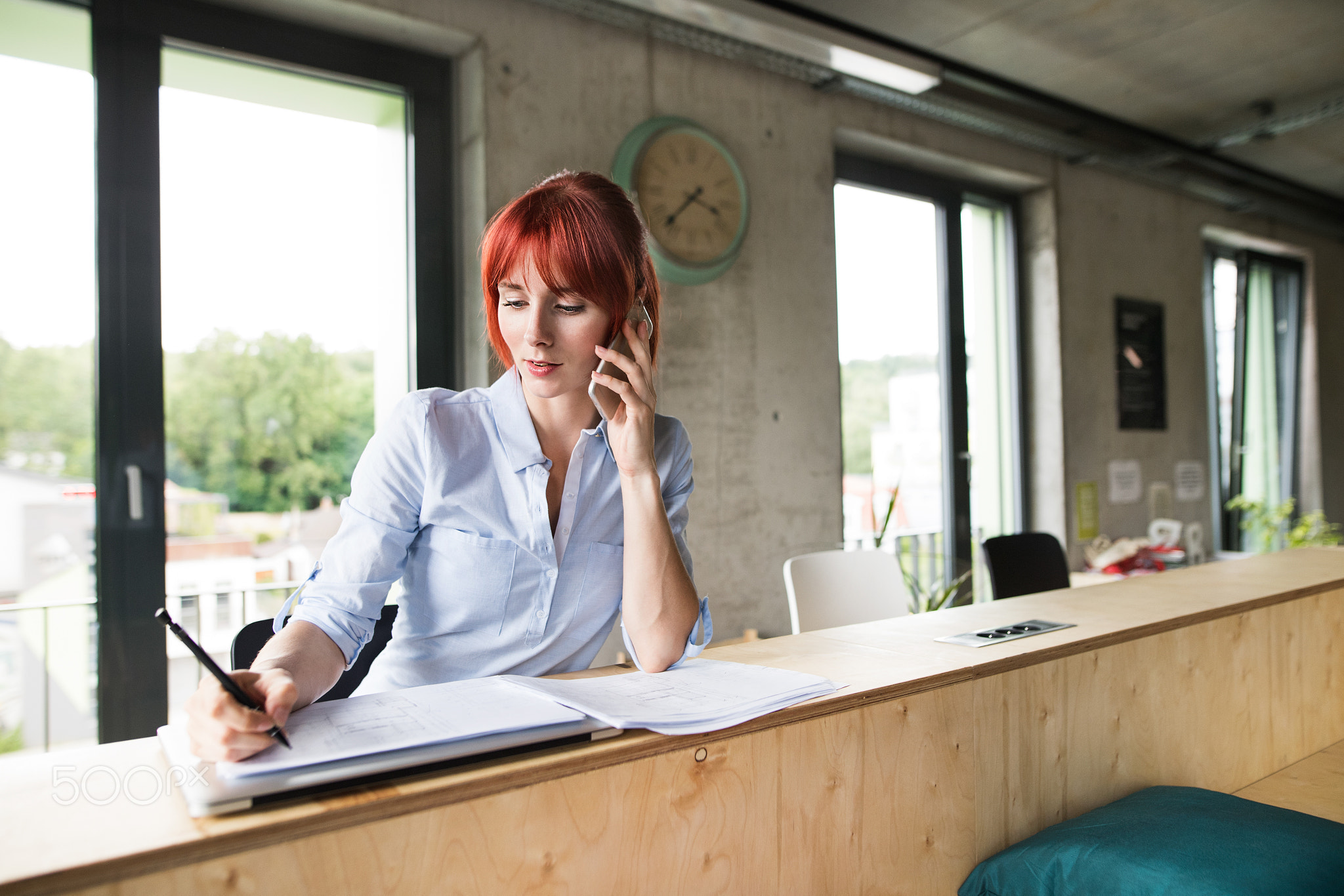 Businesswoman with smartphone in her office.