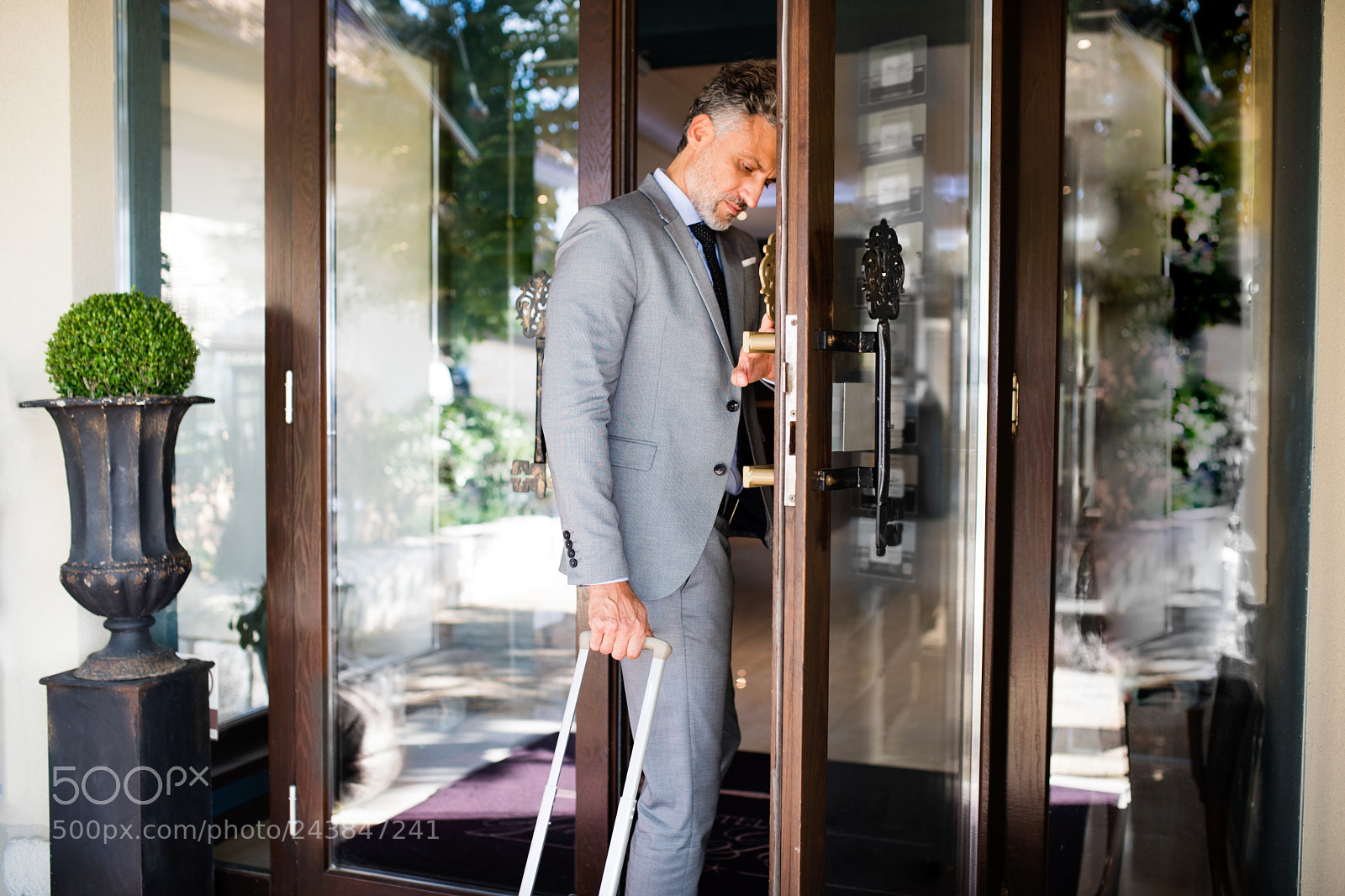 Nikon D5 sample photo. Mature businessman entering hotel photography
