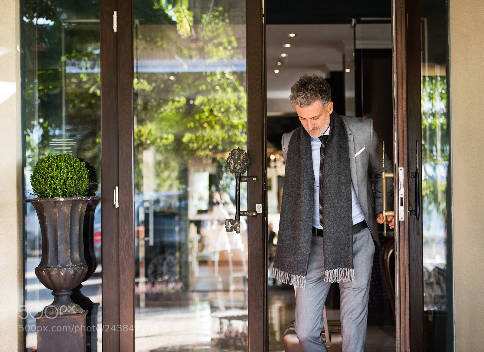 Nikon D5 sample photo. Mature businessman leaving hotel photography