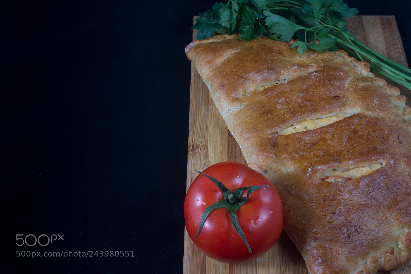 Canon EOS 1100D (EOS Rebel T3 / EOS Kiss X50) sample photo. Calzone on black background photography
