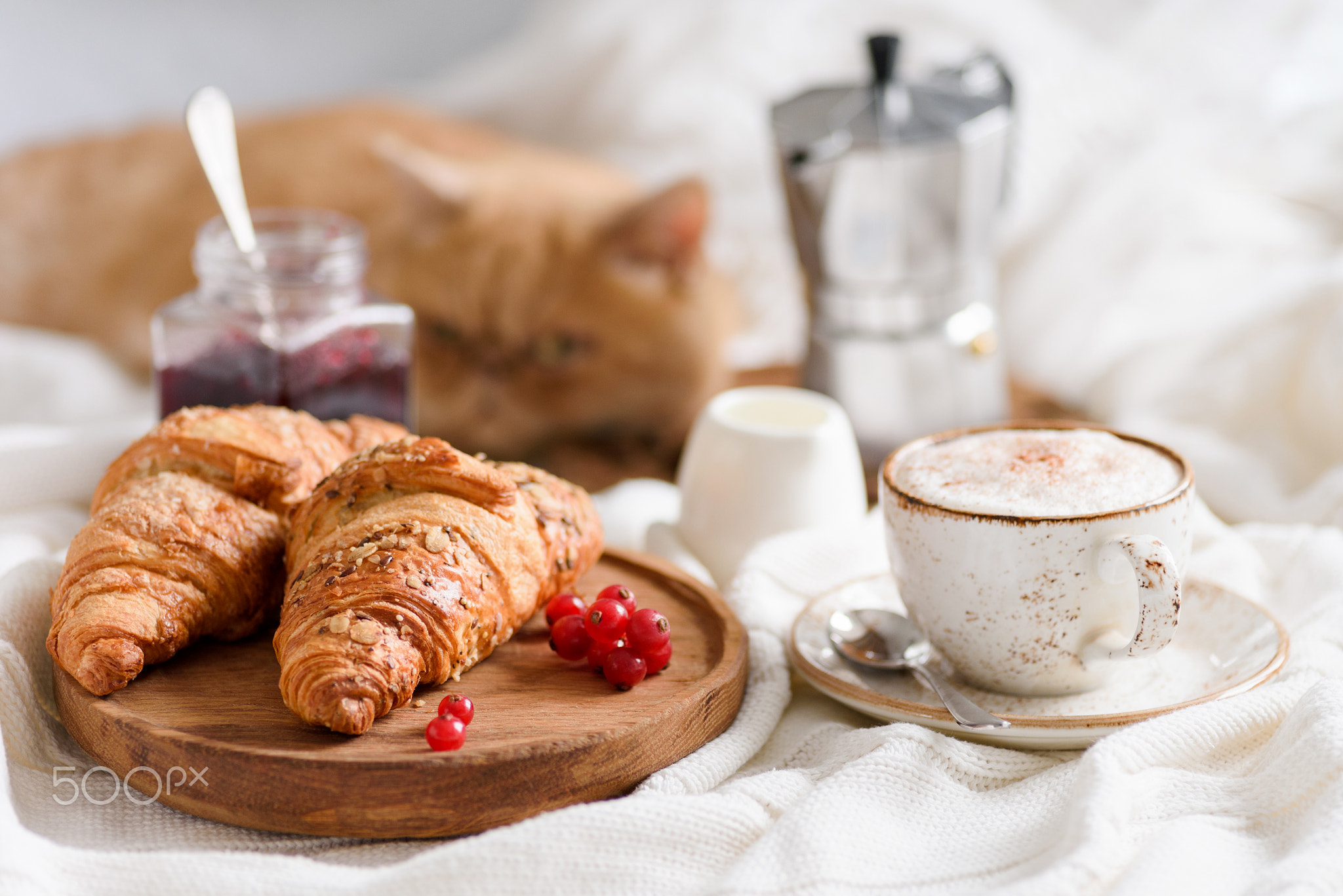 Breakfast in bed with coffee, croissants and jam