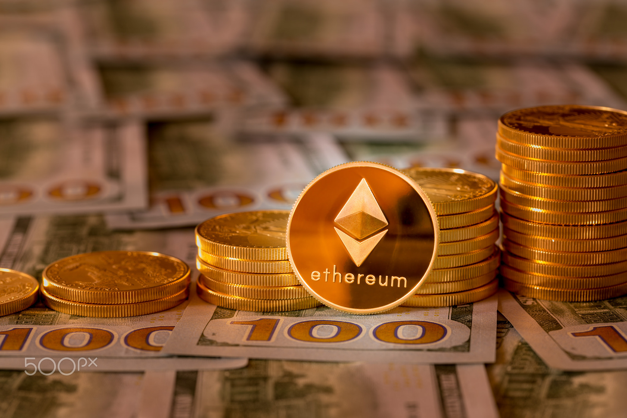Bitcoins stacked on new design 100 dollar bills