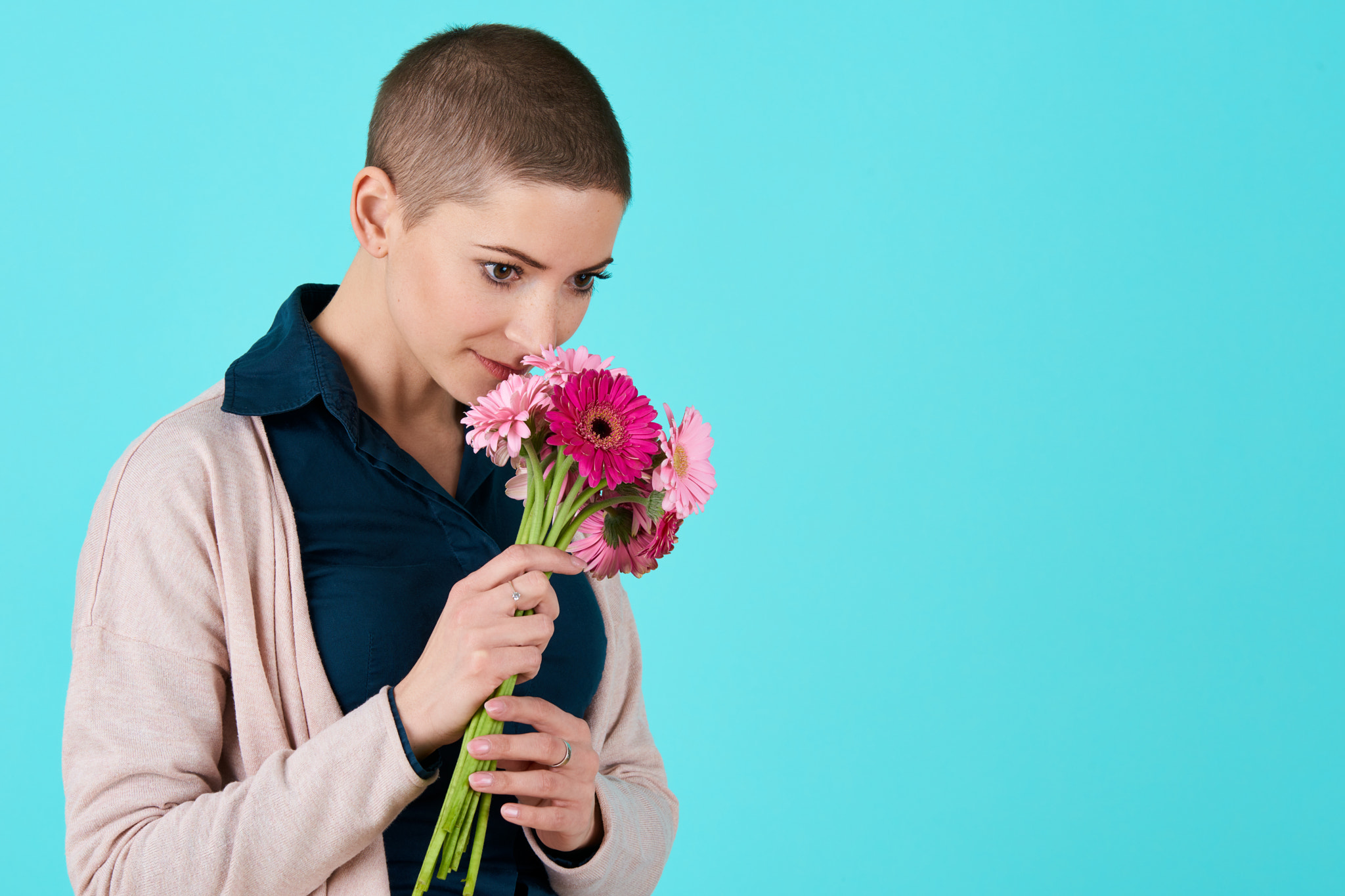 Nikon D810 + Nikon AF-S Nikkor 70-200mm F2.8G ED VR sample photo. Attractive young woman with short hair smelling bouquet of pink gerbera daisies. happy birthday... photography