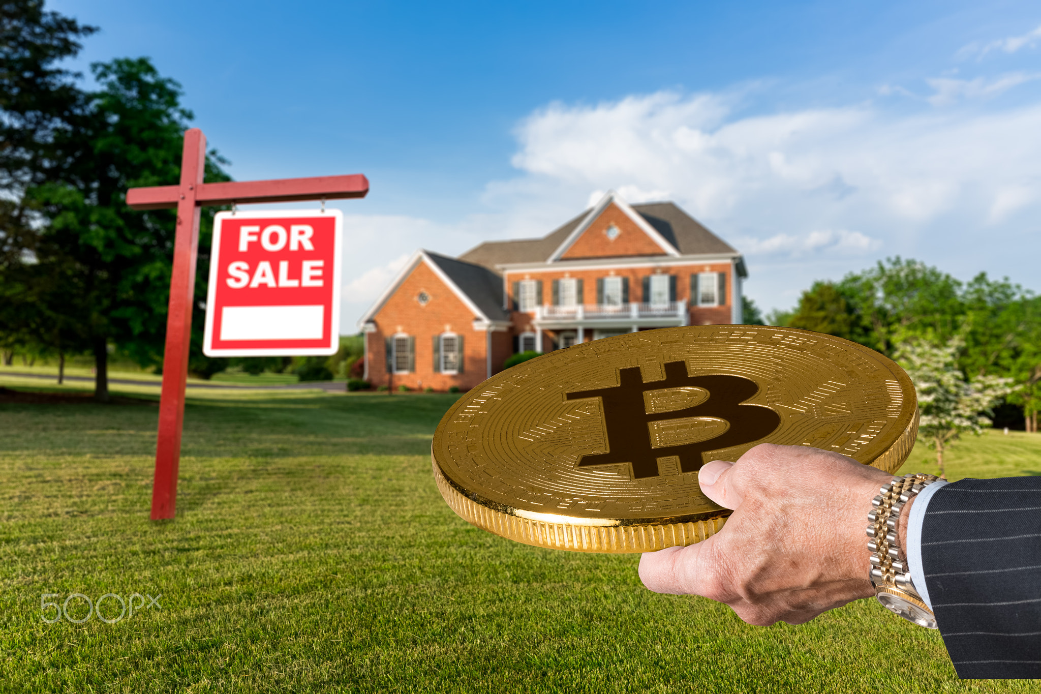 Businessman hand offering Bitcoin to buy house