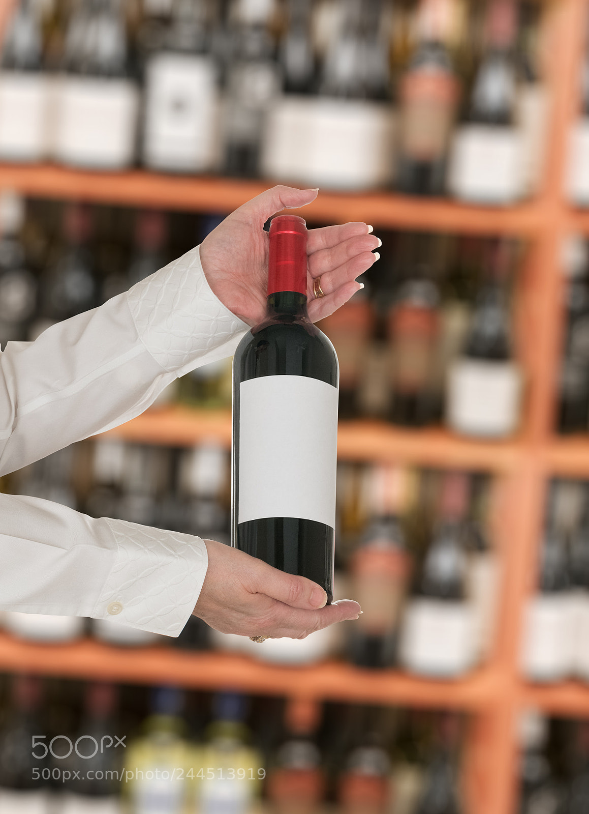Sony a7R II sample photo. Sommelier offering bottle of photography