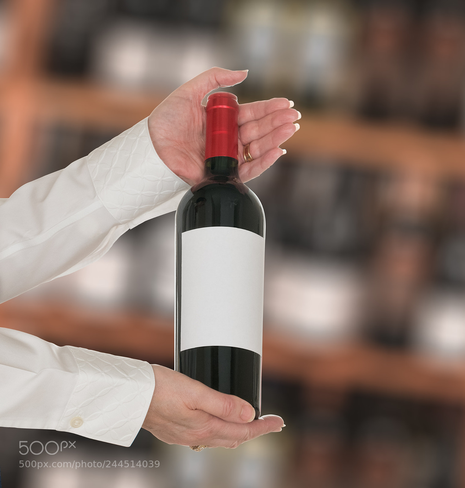 Sony a7R II sample photo. Sommelier offering bottle of photography