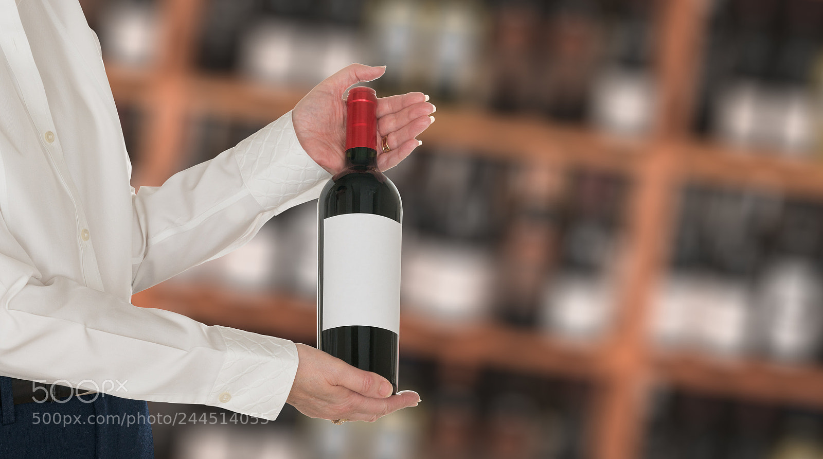 Sony a7R II sample photo. Sommelier offering bottle of photography