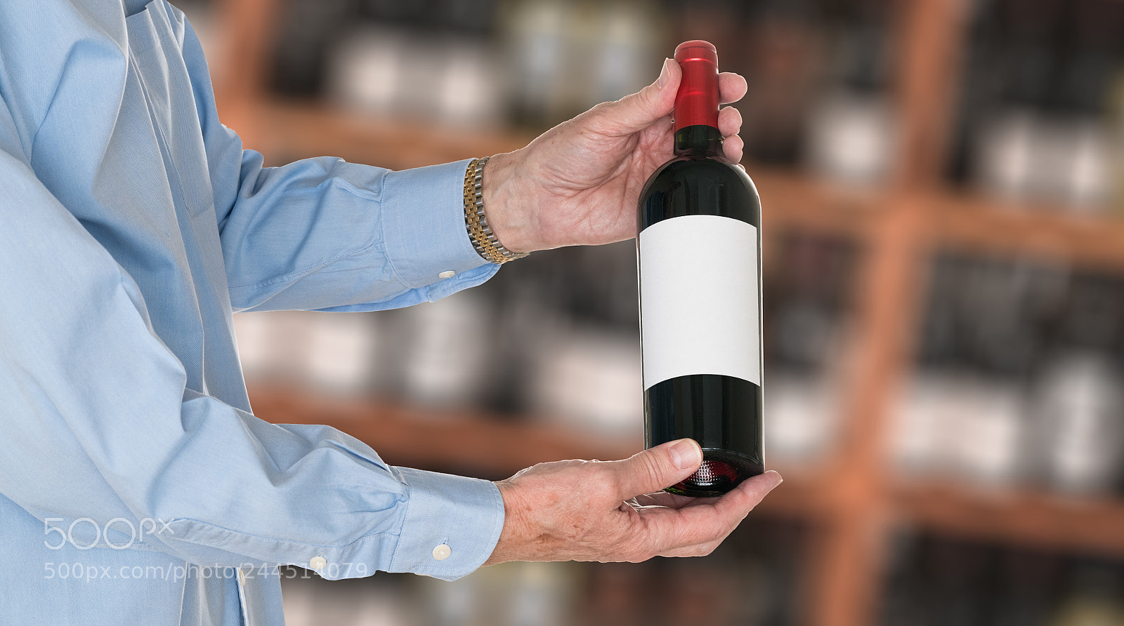 Sony a7R II sample photo. Sommelier offering bottle of photography
