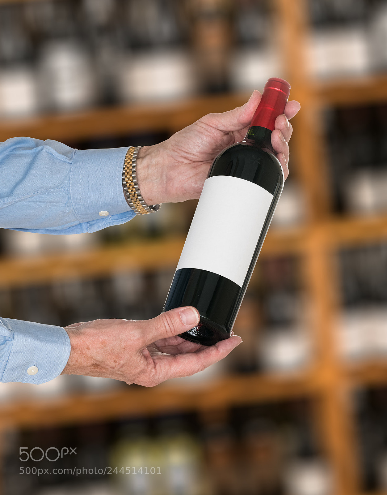 Sony a7R II sample photo. Sommelier offering bottle of photography