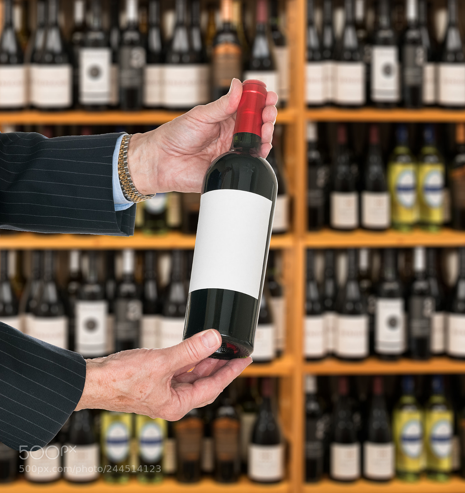 Sony a7R II sample photo. Sommelier offering bottle of photography