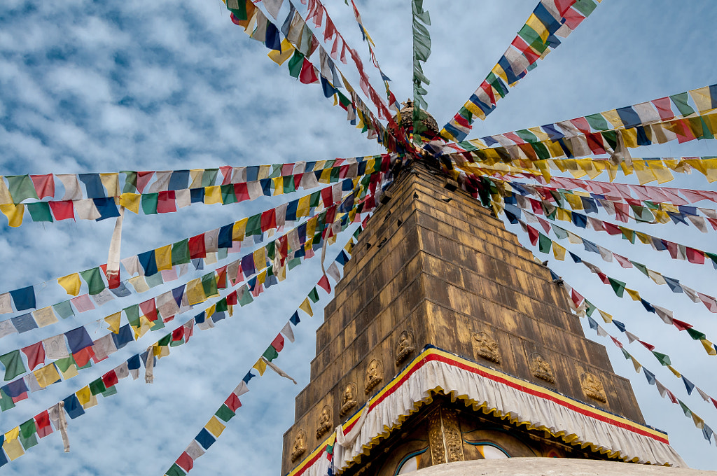 Prayer flags at the top of a stūpa by Patrick de Vries on 500px.com
