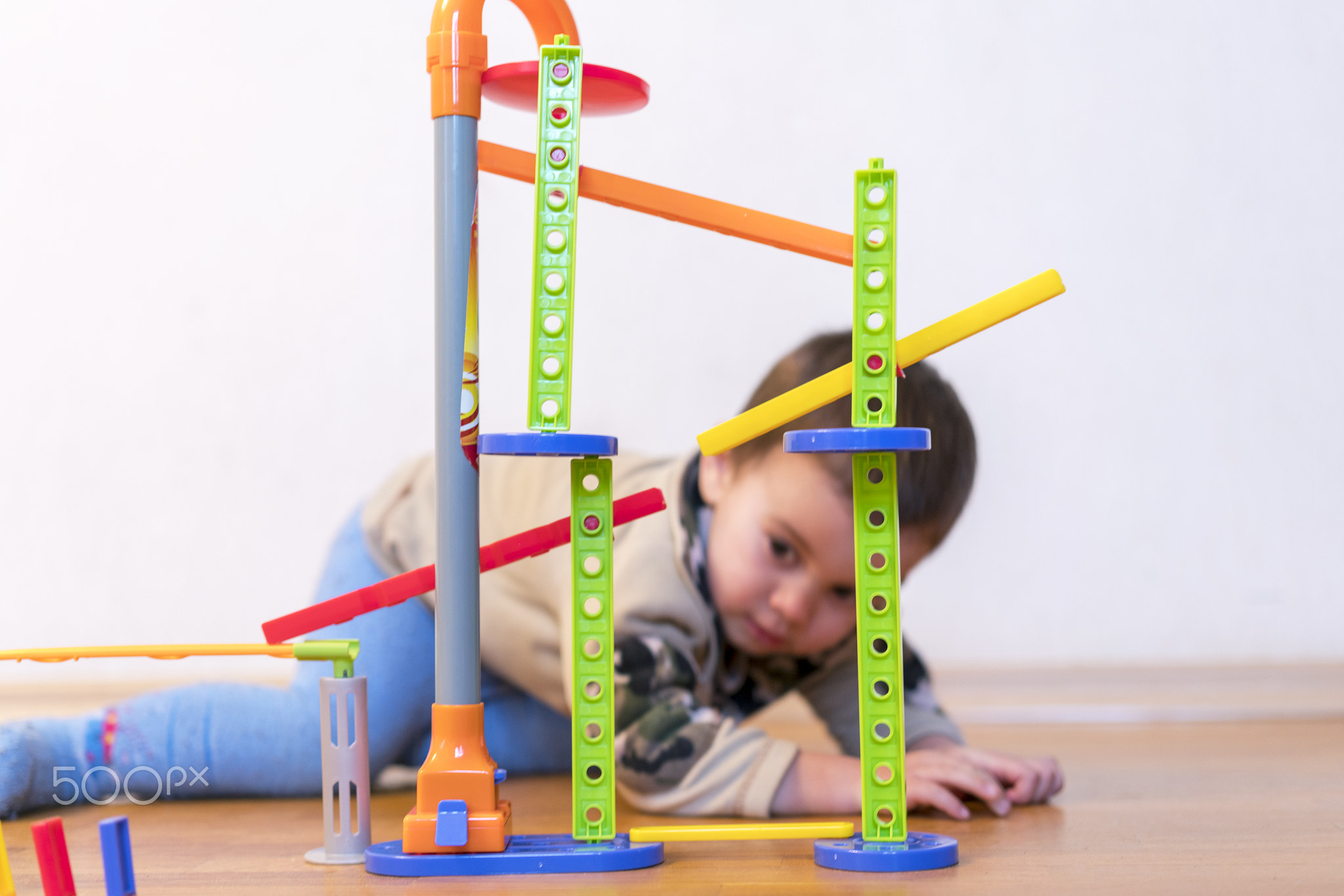 baby boy is played with colorful toys