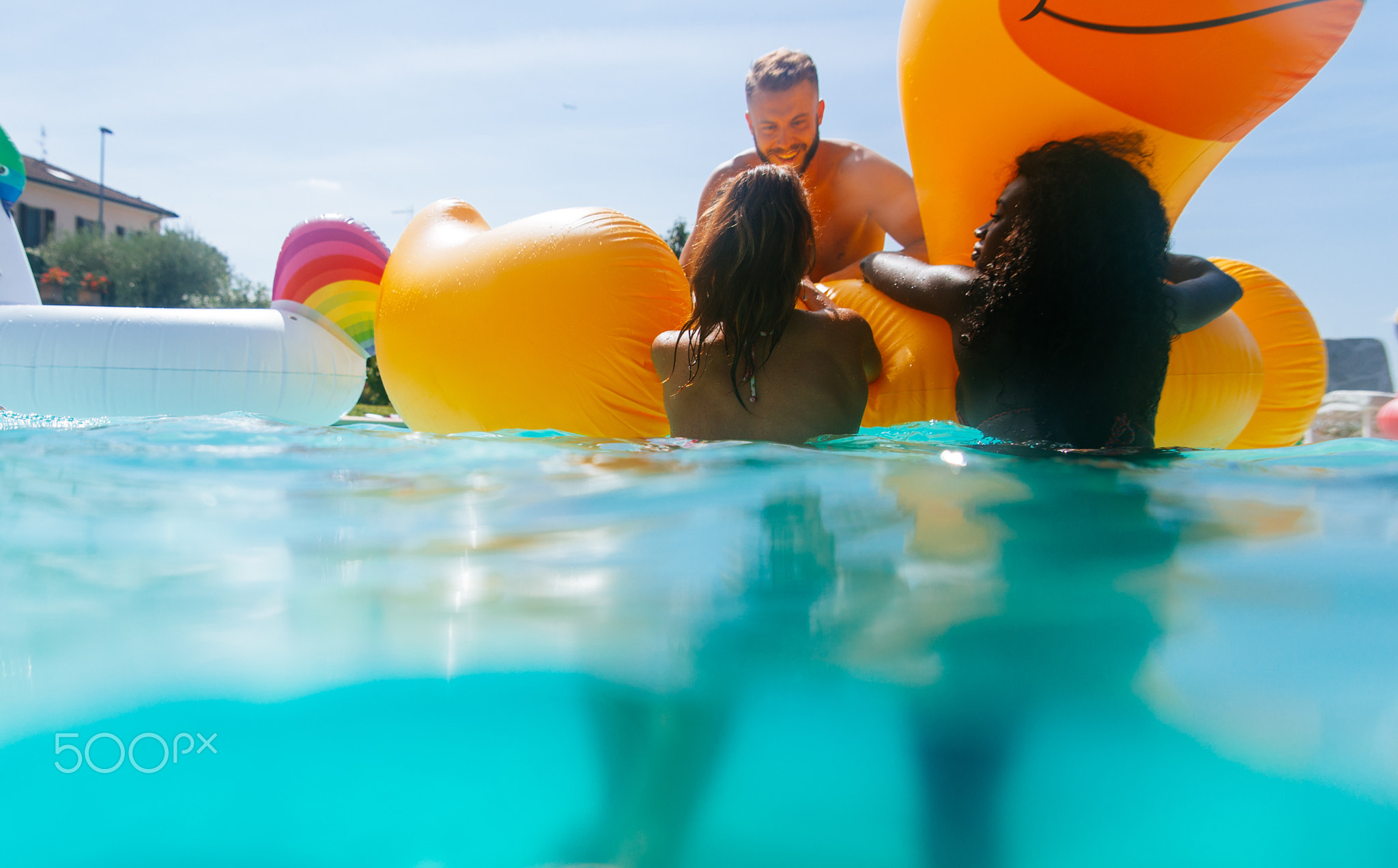 group of friends having fun in the swimming pool
