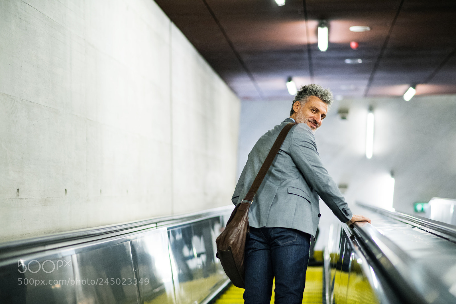 Nikon D5 sample photo. Businessman on an escalator photography