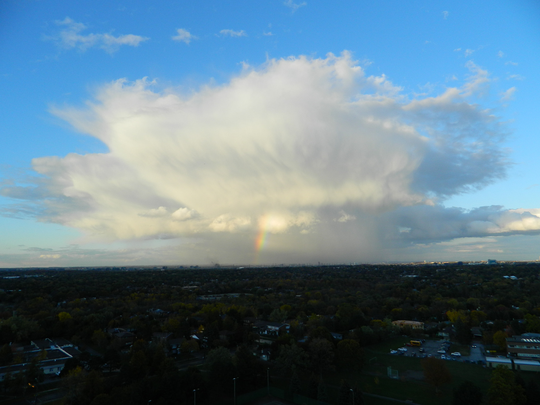 Nikon COOLPIX L310 sample photo. Huge cloud with a tiny rainbow photography