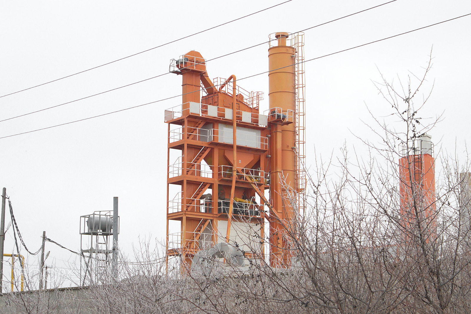 Canon EOS M10 sample photo. Power line in front of orange mixing block of asph photography