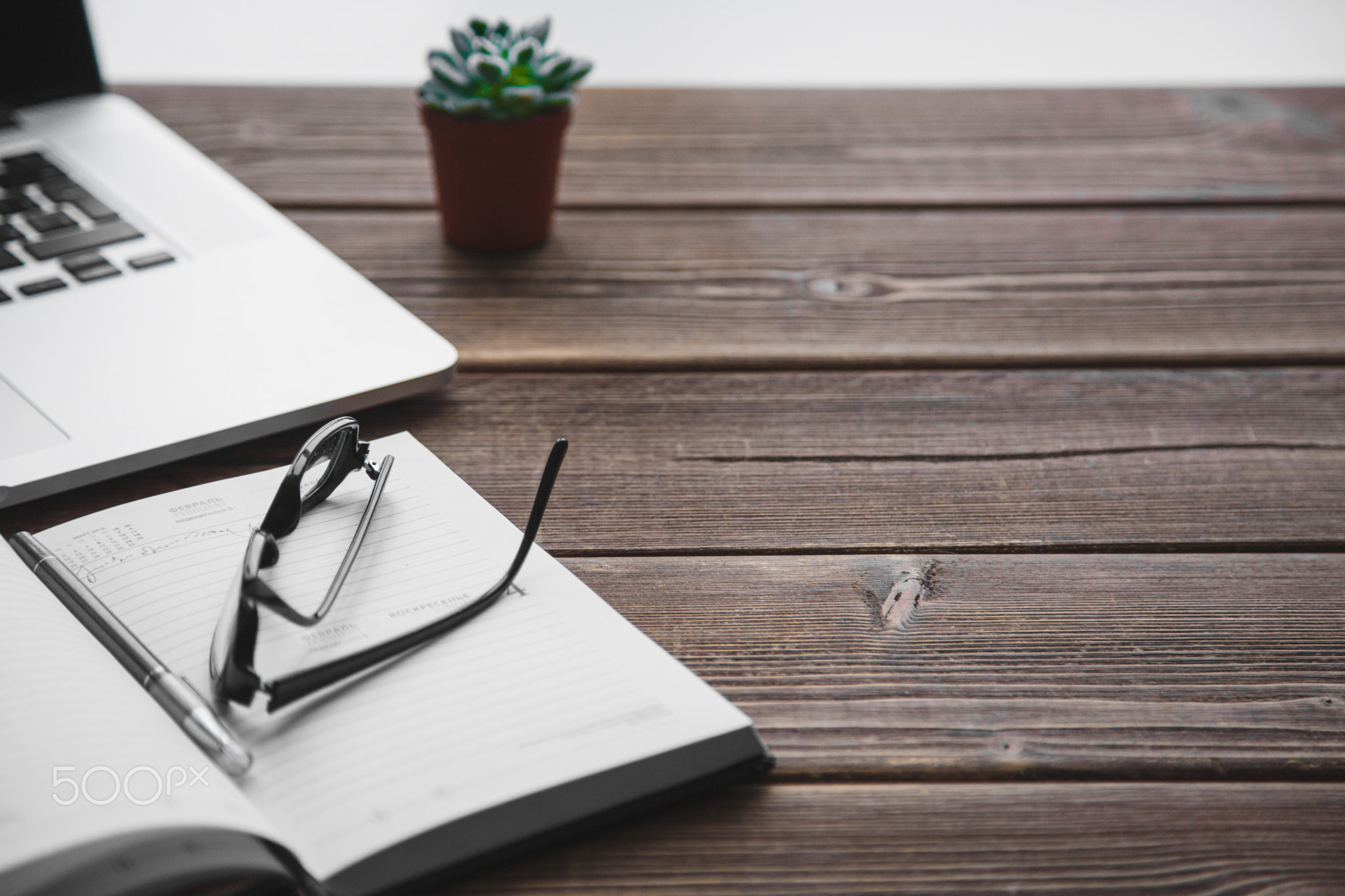 Working place with laptop on wooden table