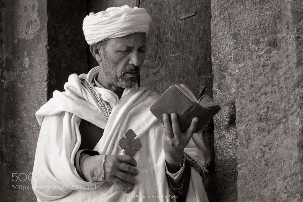 Fujifilm X-T2 sample photo. Priest engaged in bible photography
