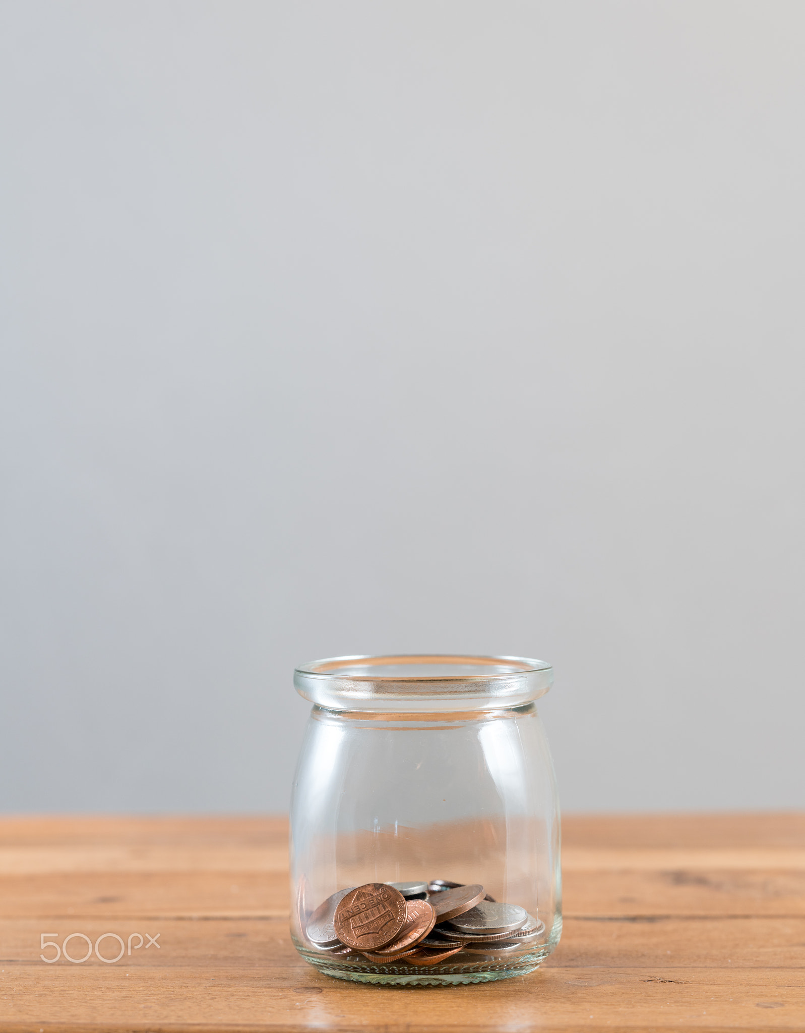 Loose change inside glass jar to represent retirement savings