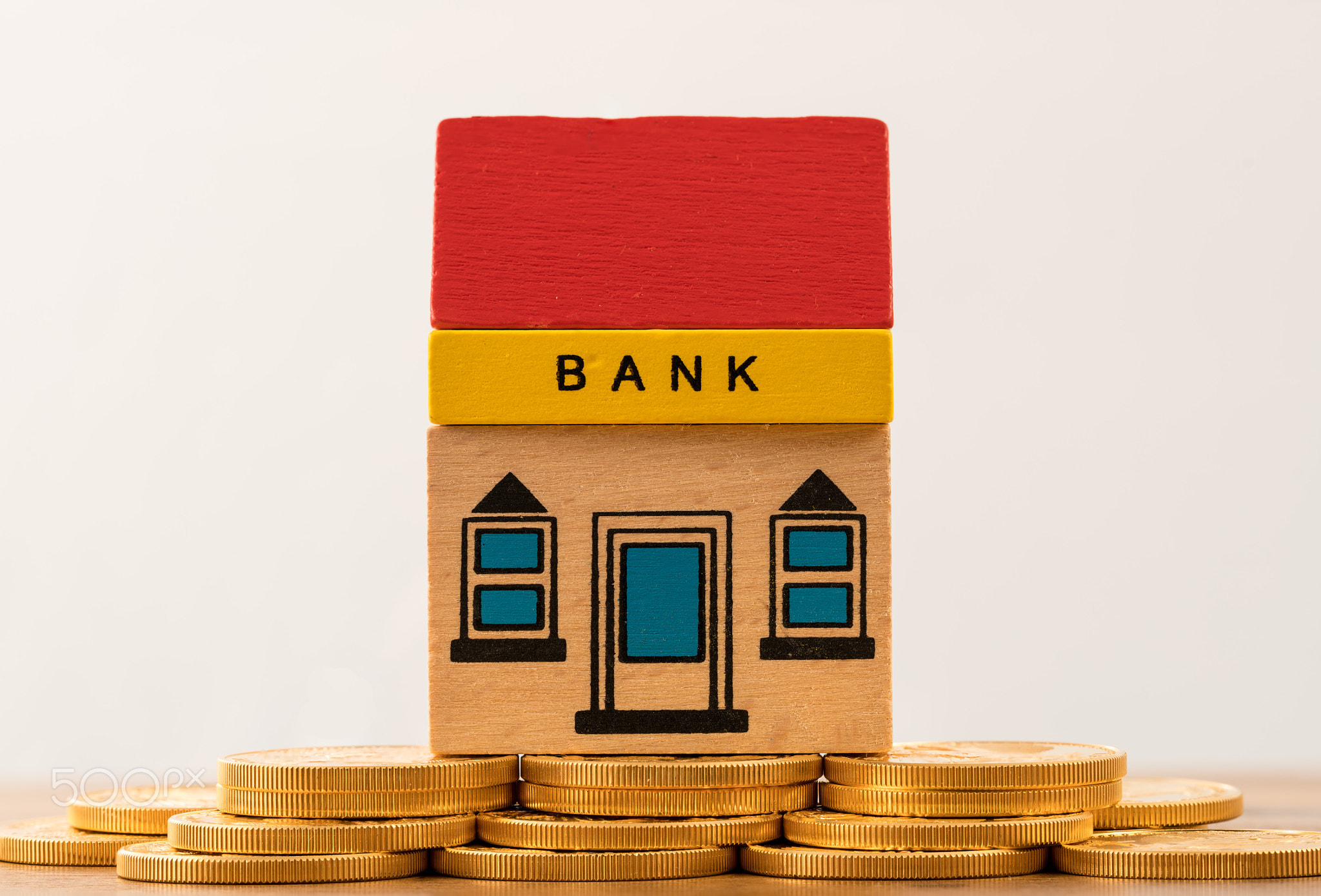 Toy bank building on gold coin assets