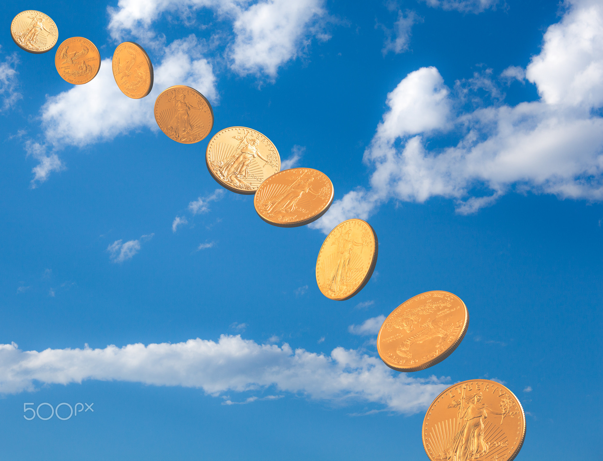 Stream of gold coins falling from blue sky