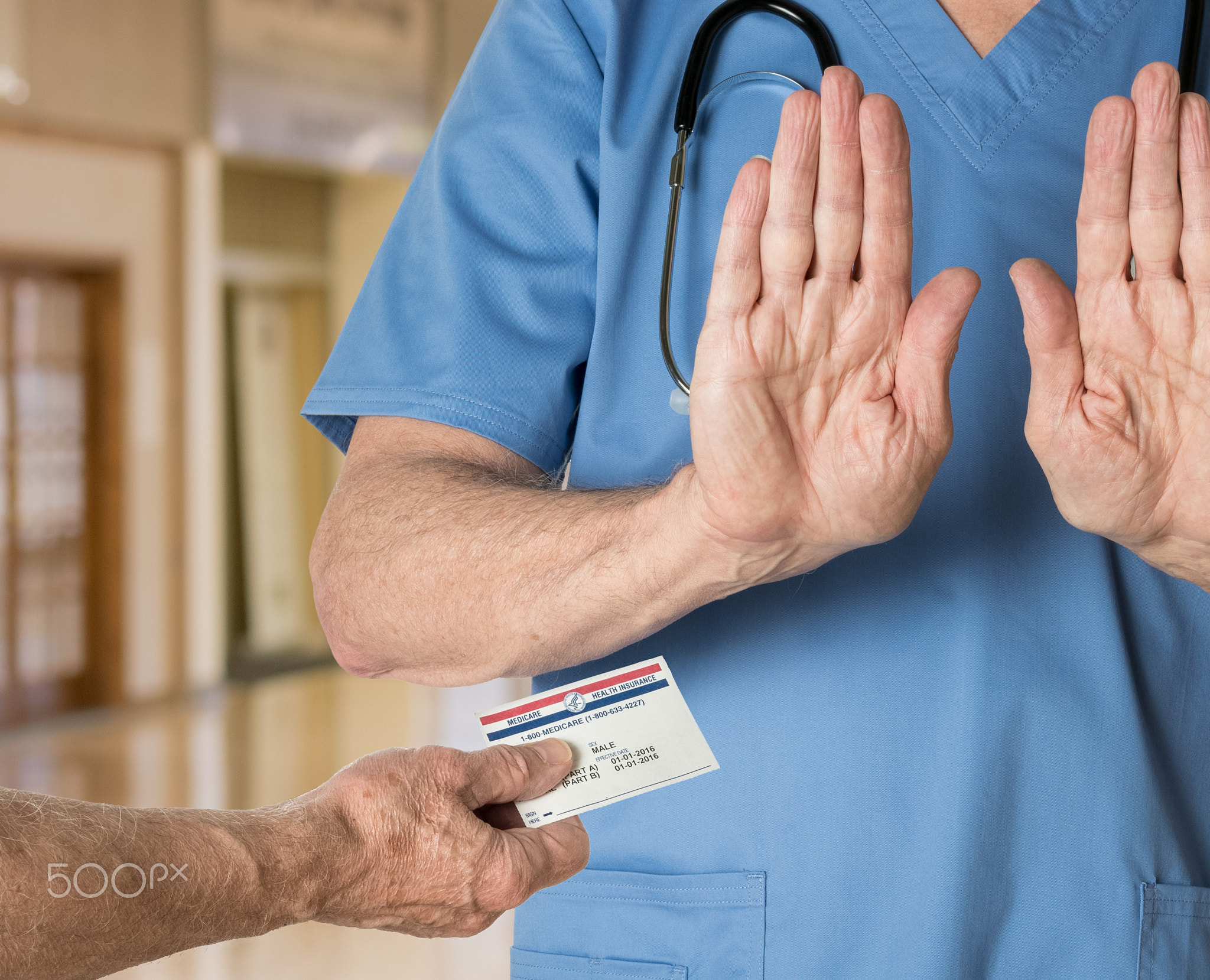 Senior doctor in scrubs refusing Medicare Card