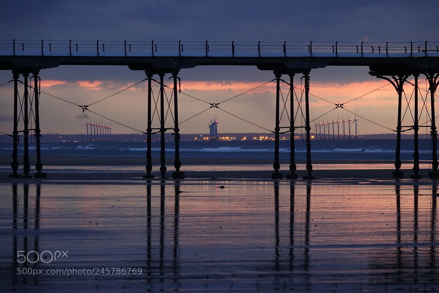Sony Cyber-shot DSC-RX10 III sample photo. Windfarm through pier photography