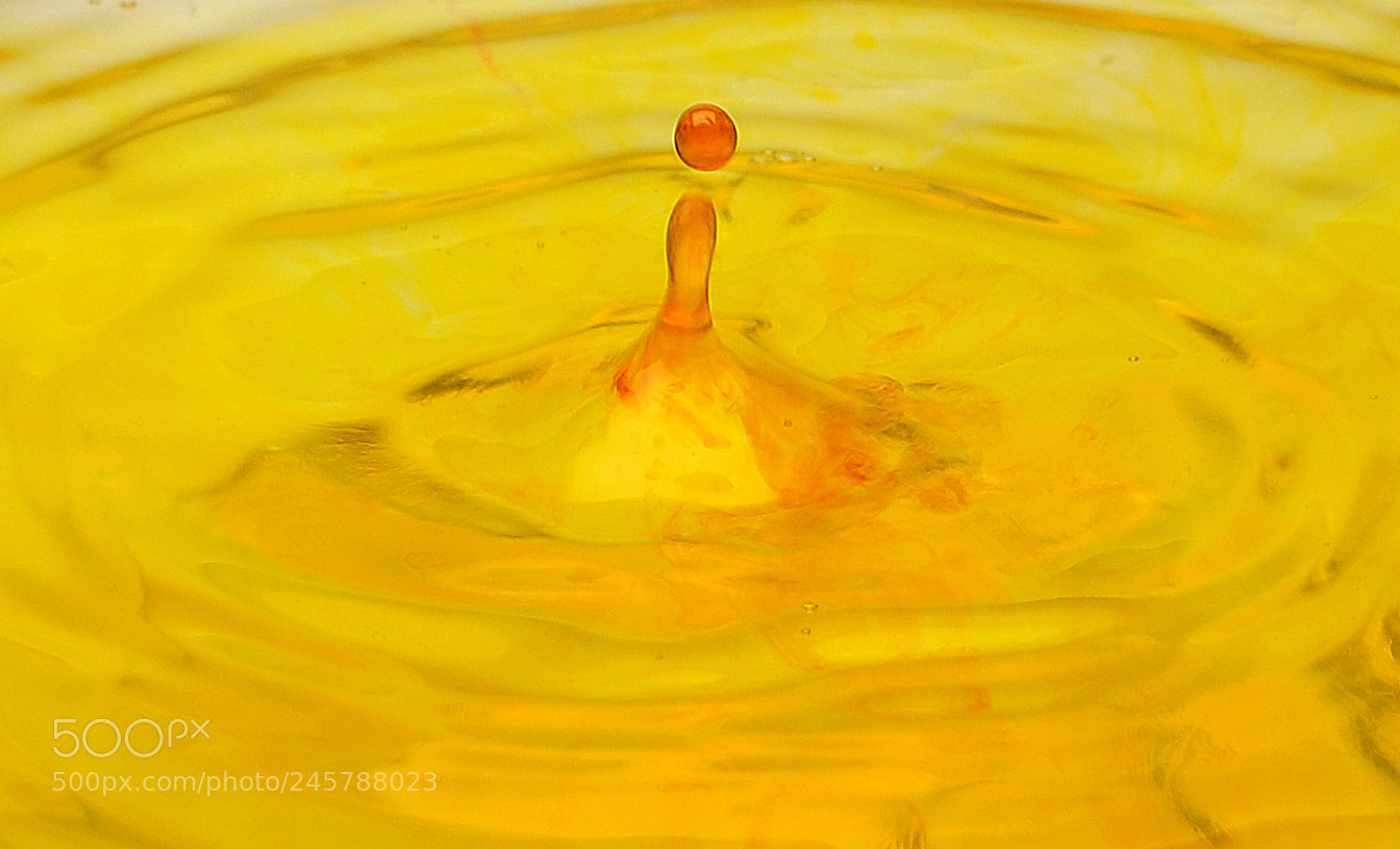 Nikon D90 sample photo. Yellow ink droplets photography
