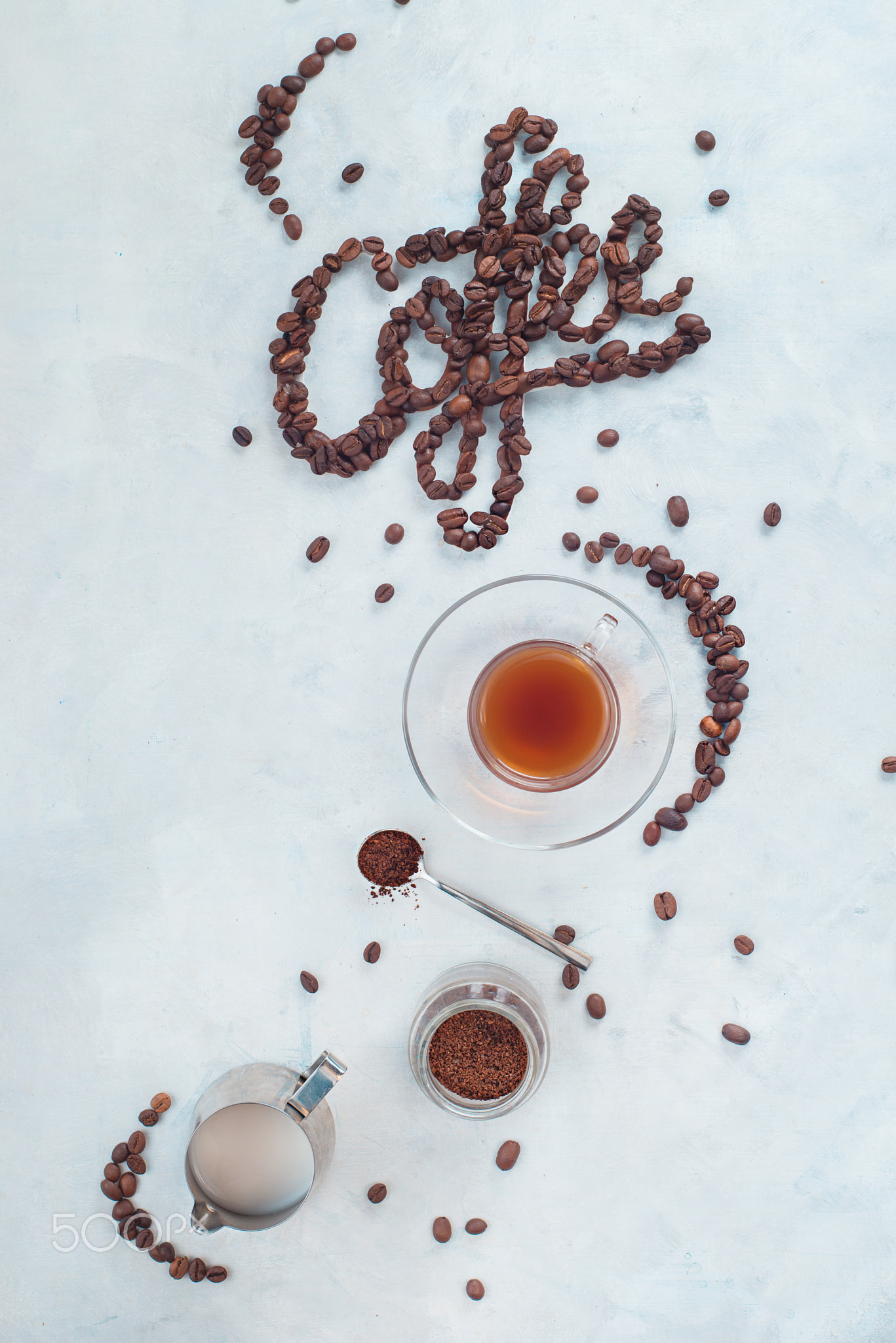 Food lettering in high key drink photography from above. Word Coffee made with coffee beans. Moka...