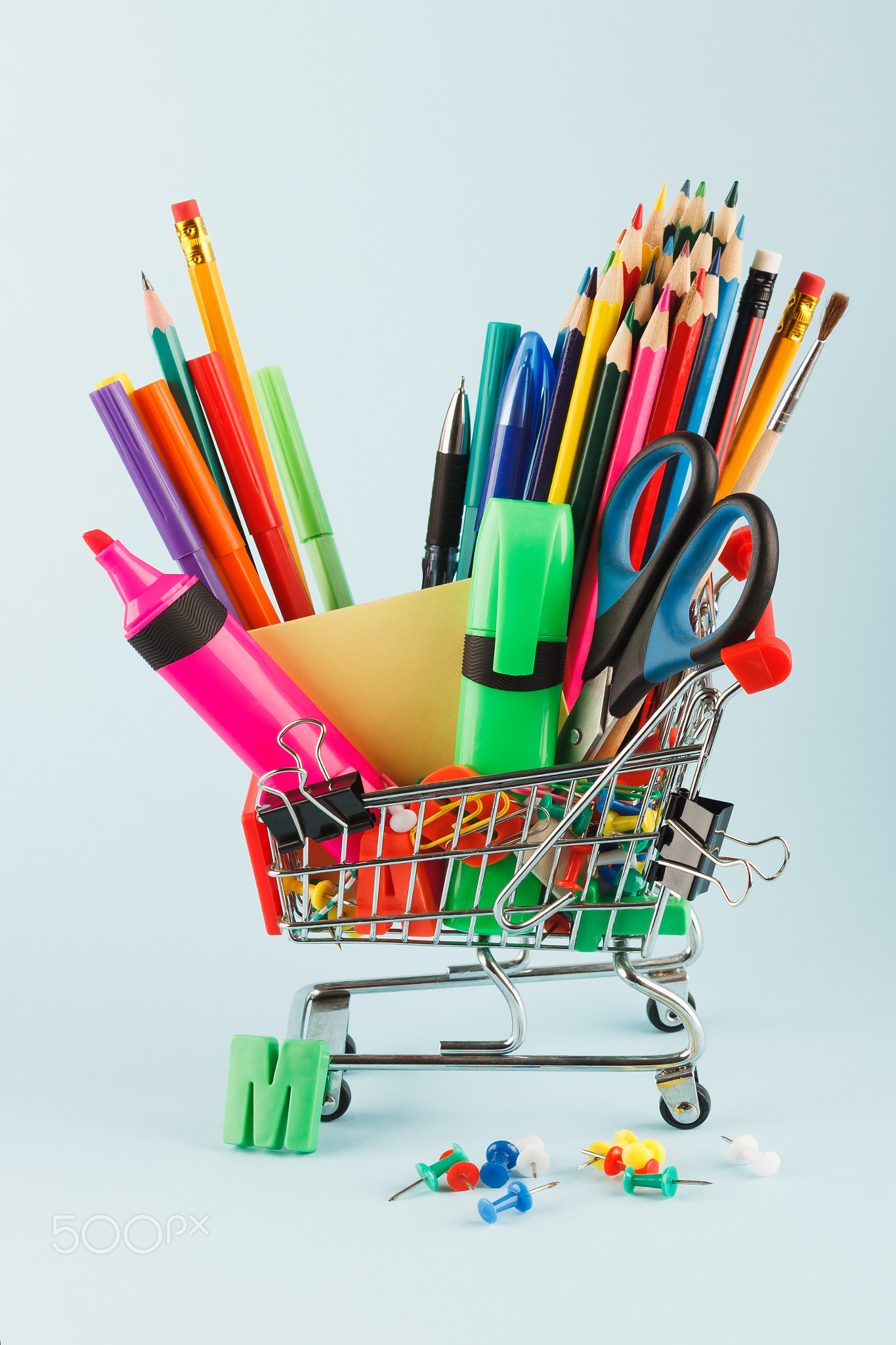 Shopping cart with different stationery, light blue background