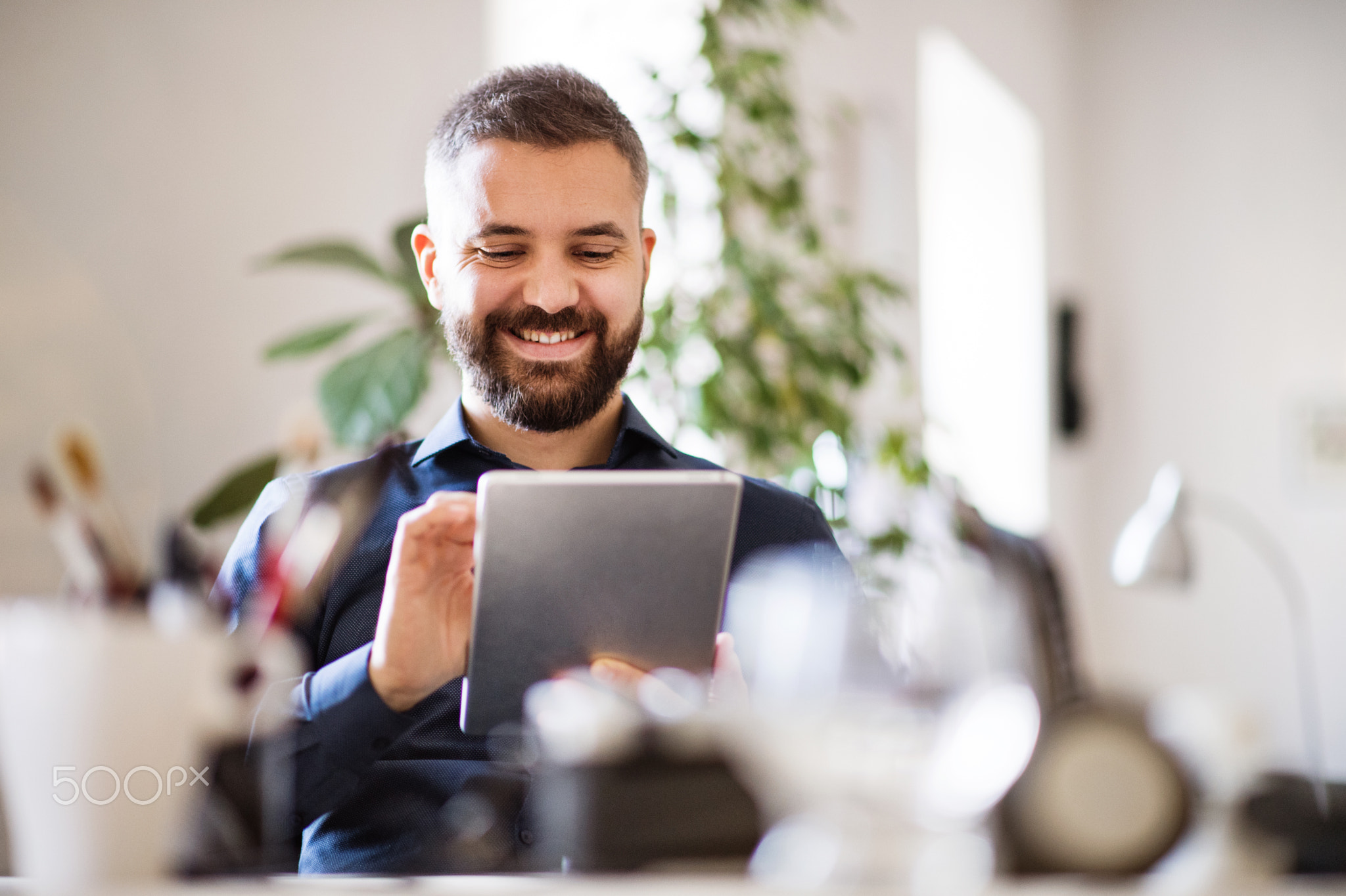 Businessman with tablet in his office.