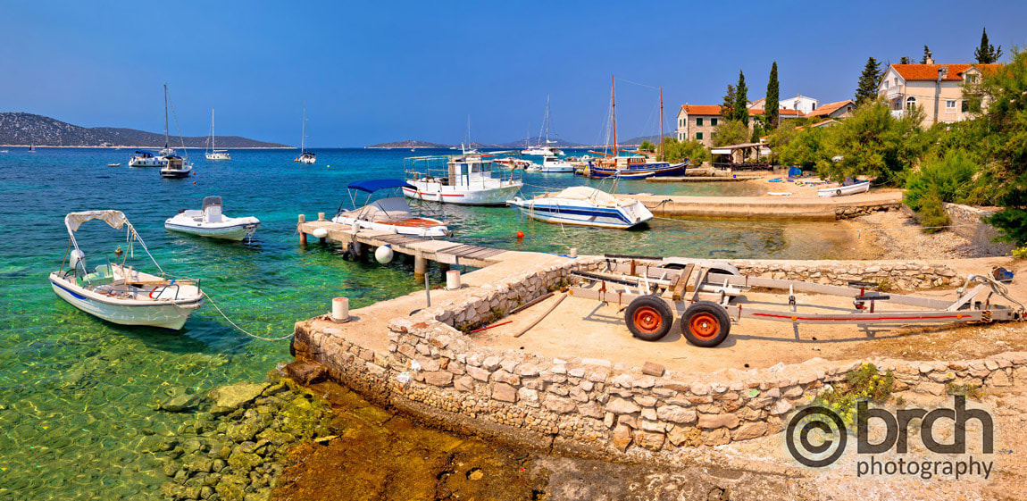 Coast and beach of Prvic island panoramic summer view