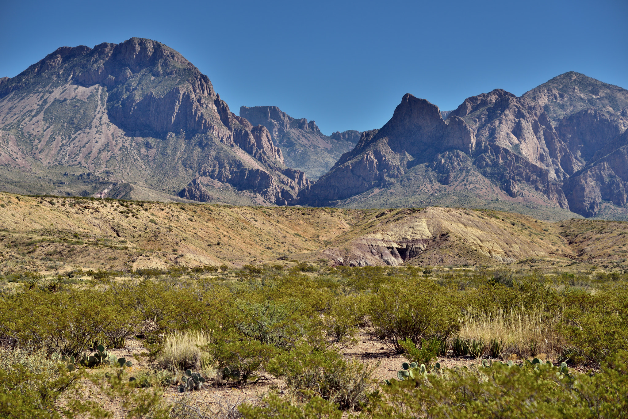 Nikon AF-S Nikkor 24-120mm F4G ED VR sample photo. Rolling hillsides leading to jagged peaks photography