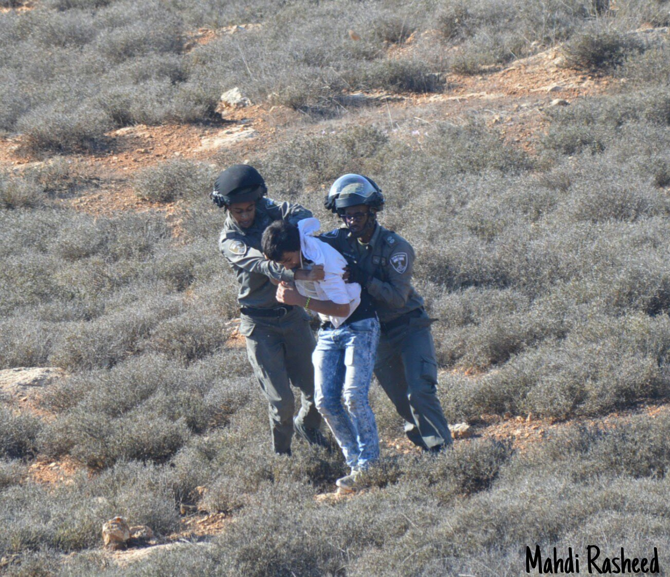 Nikon D3200 + Nikon AF-S DX Nikkor 55-200mm F4-5.6G VR II sample photo. An israeli terrorist arresting a young palestinian photography