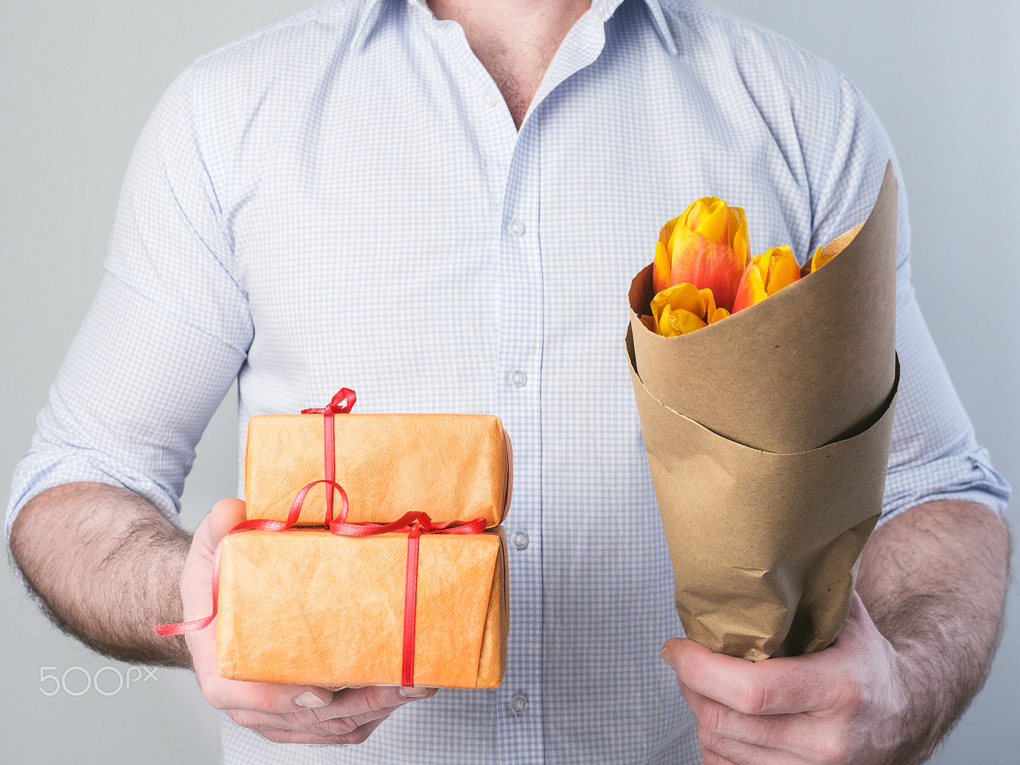 Man with gifts and flowers