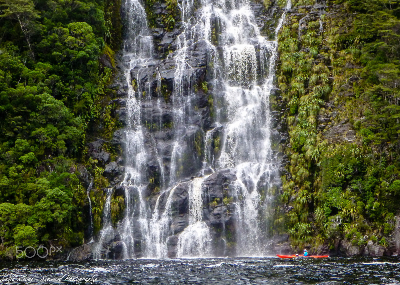 Panasonic DMC-FT4 sample photo. Waterfall and kayaker, fjordland, new zealand photography