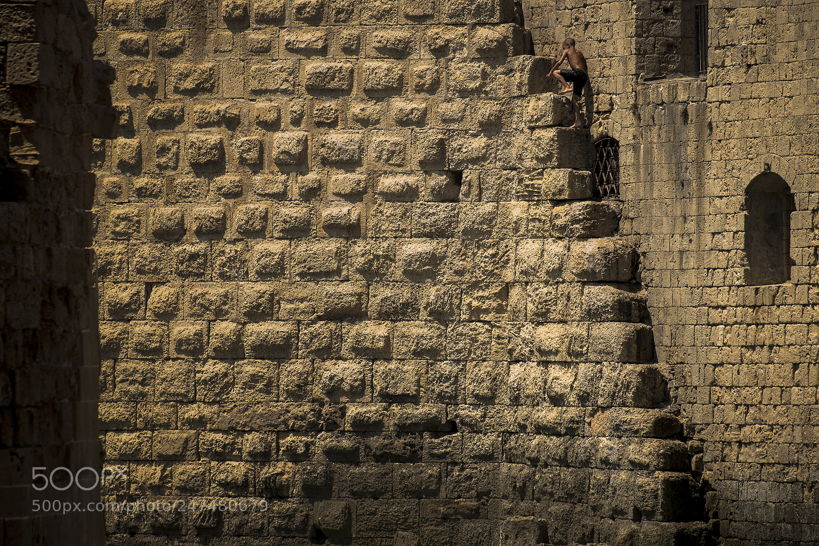 Fujifilm X-Pro1 sample photo. Boy climbing fortified walls photography