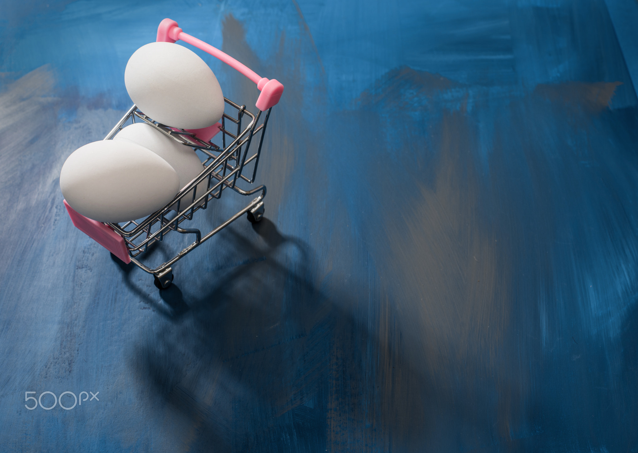 White eggs in a shopping cart, perfect Easter sale, deal, promotional background