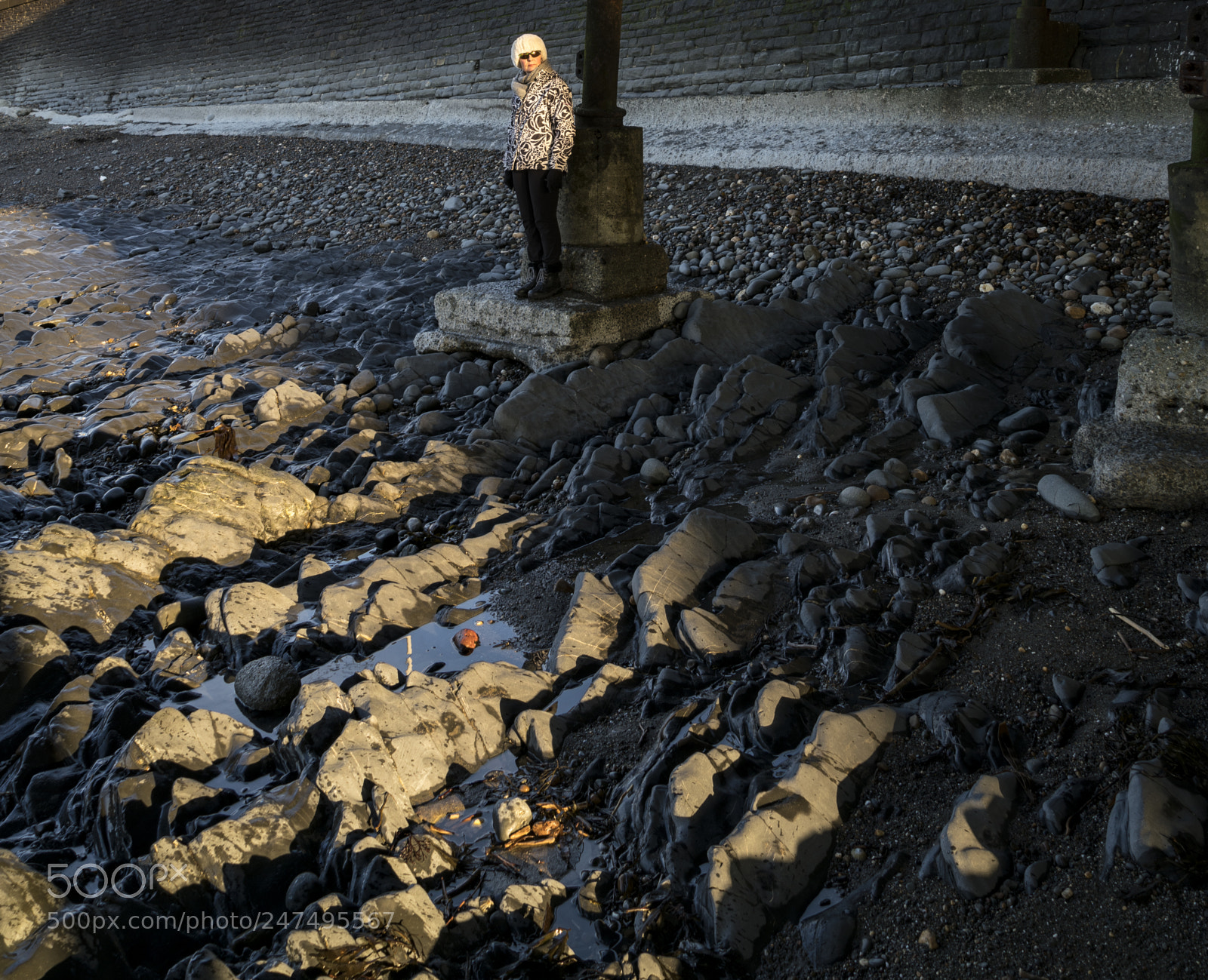 Sony a7R II sample photo. A woman staning underneath photography